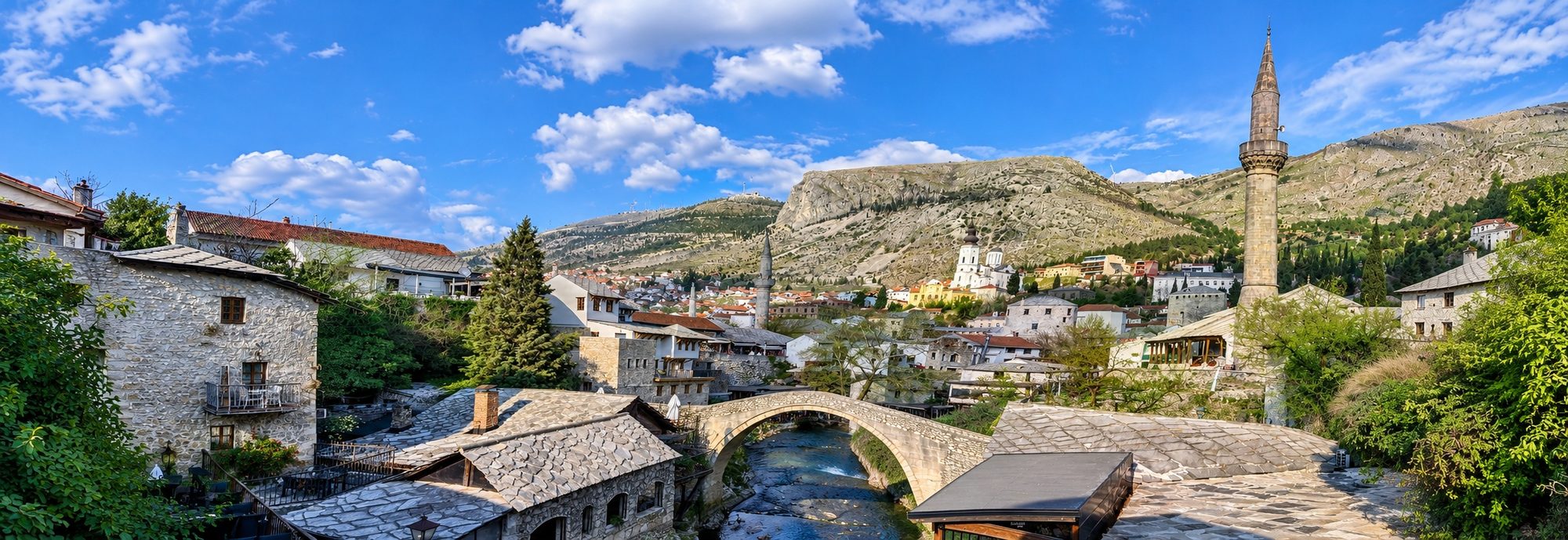 A Balkan river valley town at dusk