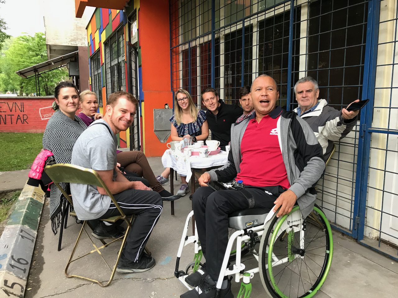 Friends gathered around an outdoor café table