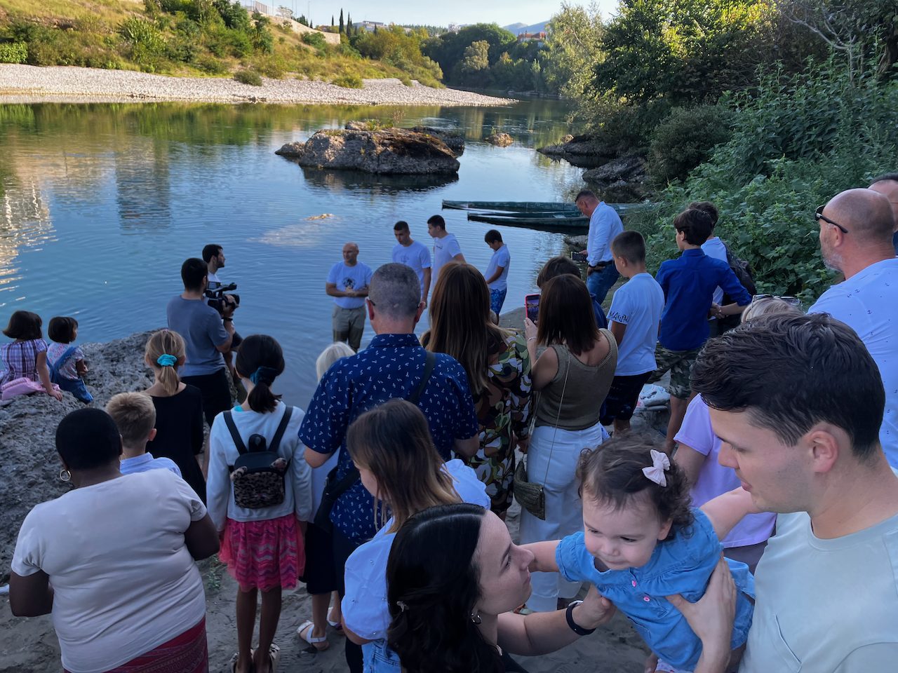 A gathering of families beside a river