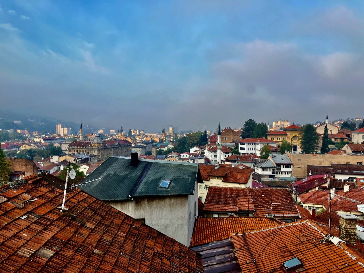 Misty rooftops and minarets of Sarajevo's old town at dawn