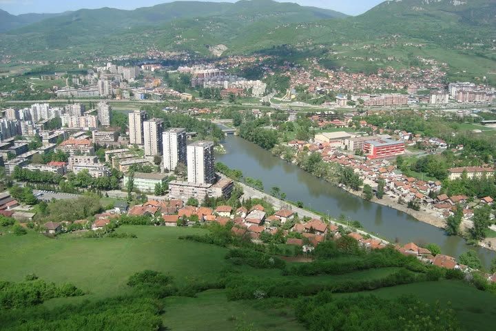 A wide view over a Balkan town and its river valley